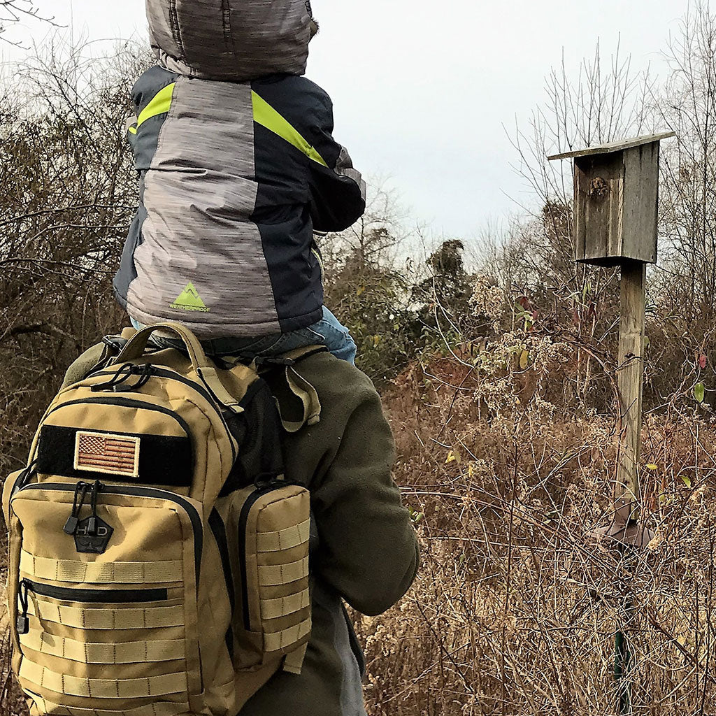 Man using Diaper Bag Backpack and carrying a child on his shoulders
